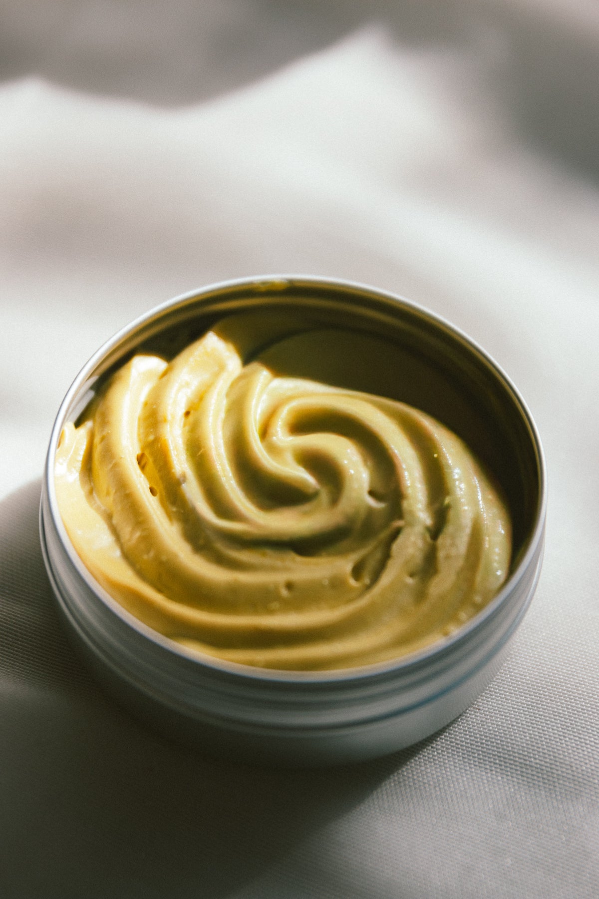 Open tin of Bless the Baby showing the soft grass-fed tallow baby balm