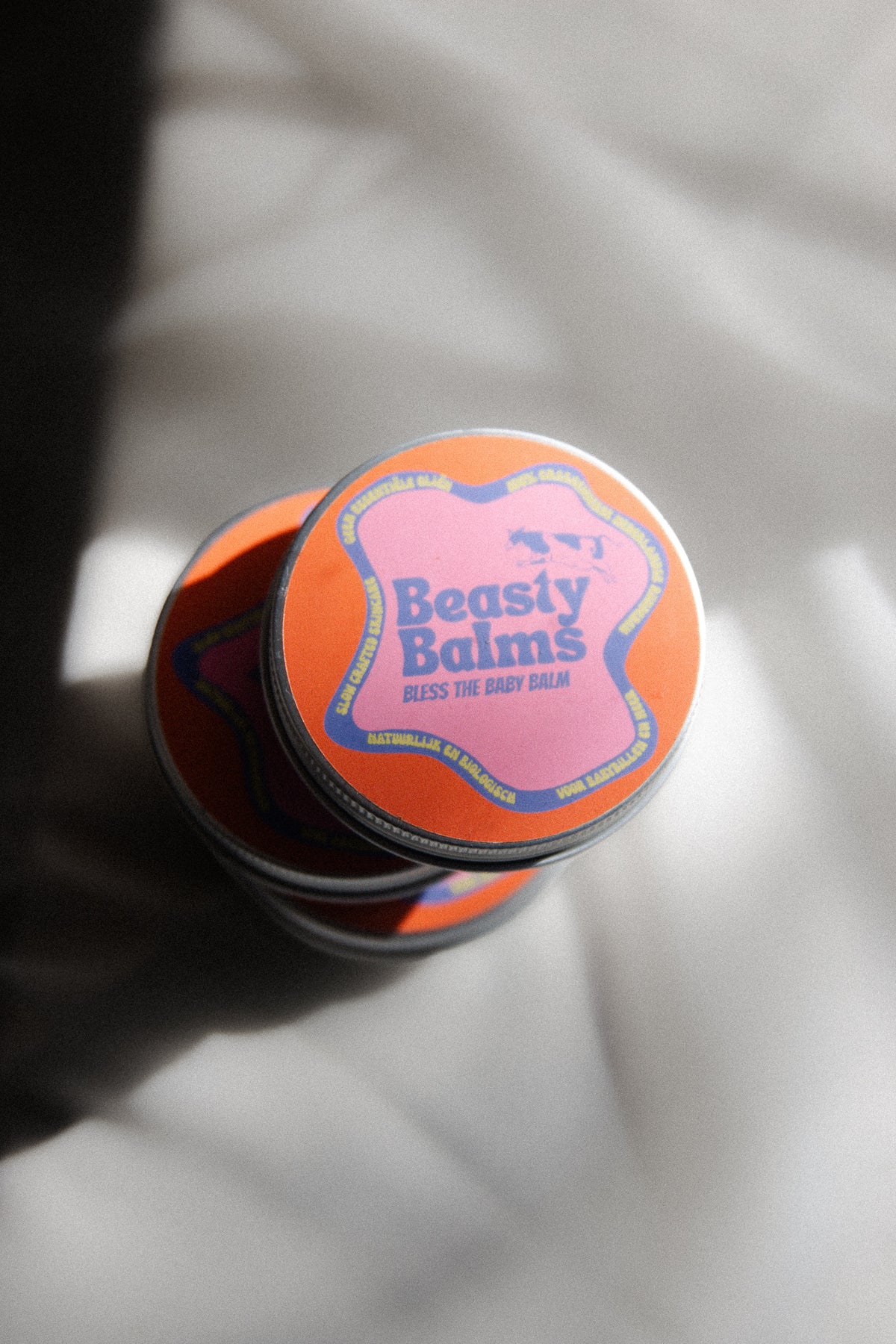 Top view of a tin of Bless the Baby tallow baby balm by Beasty Balms