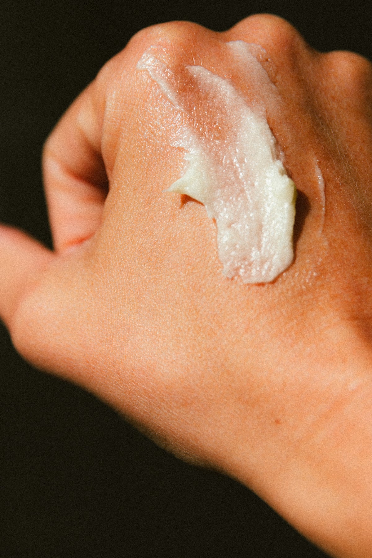 Creamy texture of Face the Beast tallow balm on a hand