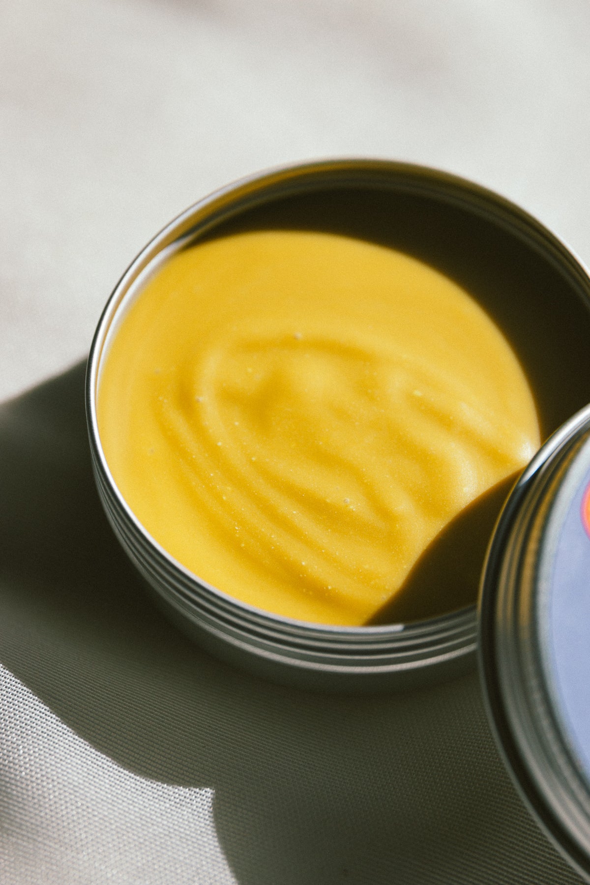 Open tin of Save Our Skins showing the organic beef tallow balm